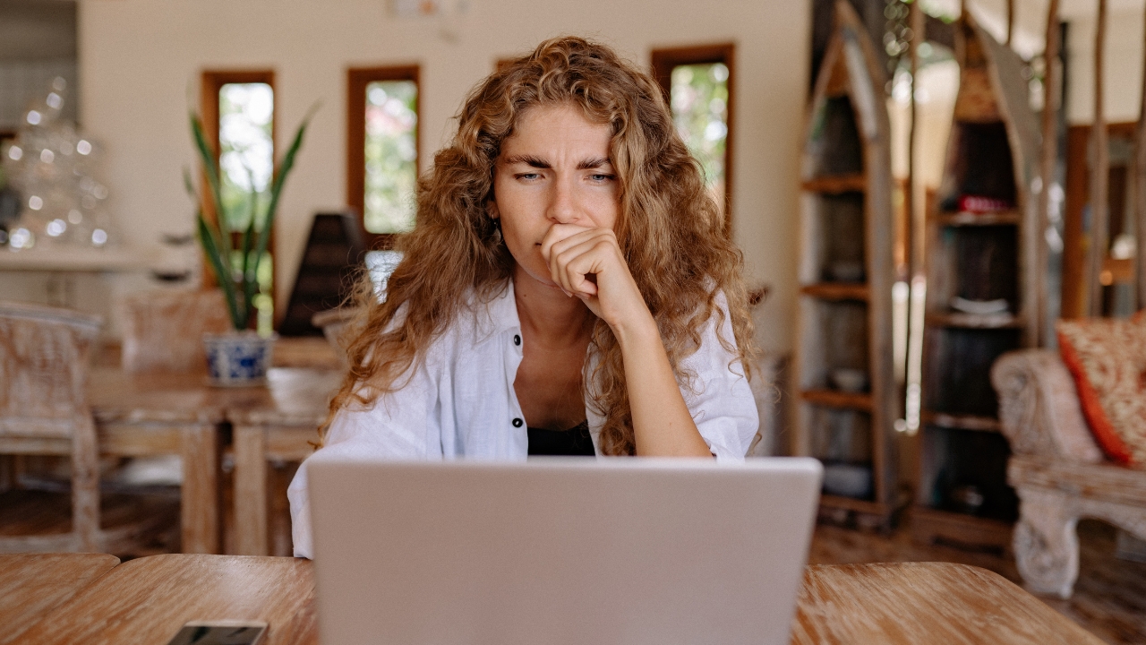 Woman thinking in front of laptop - Psychiatrist in Naperville